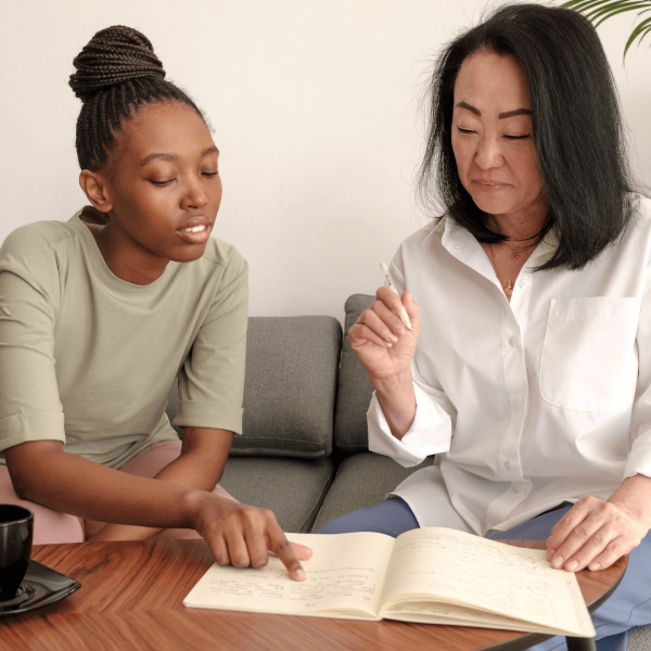 Compliance coordinator job opening Women discussing compliance coordinator job opening